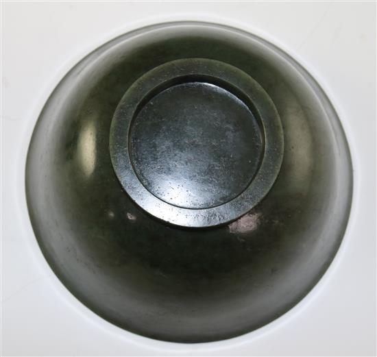 A Chinese spinach green jade bowl, 18th century, diameter 19cm, wood stand